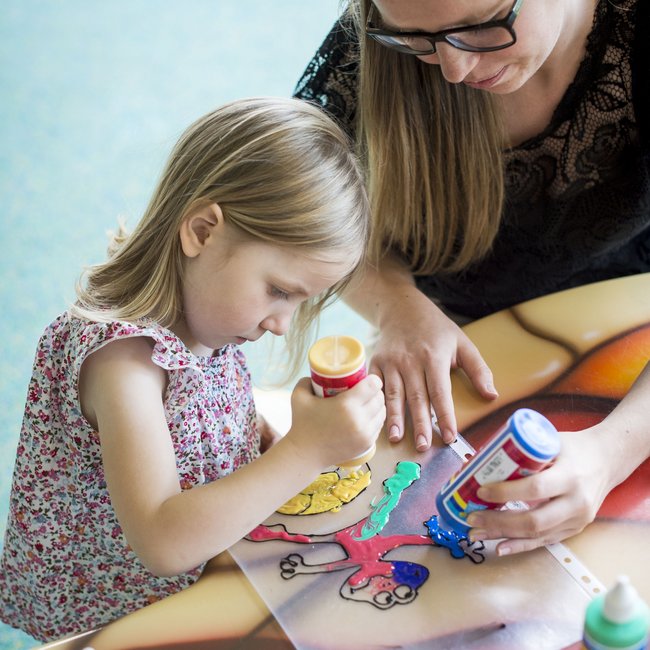Family hotels in South Tyrol with 4-star-superior service Girl and woman painting a drawing with colorful paints