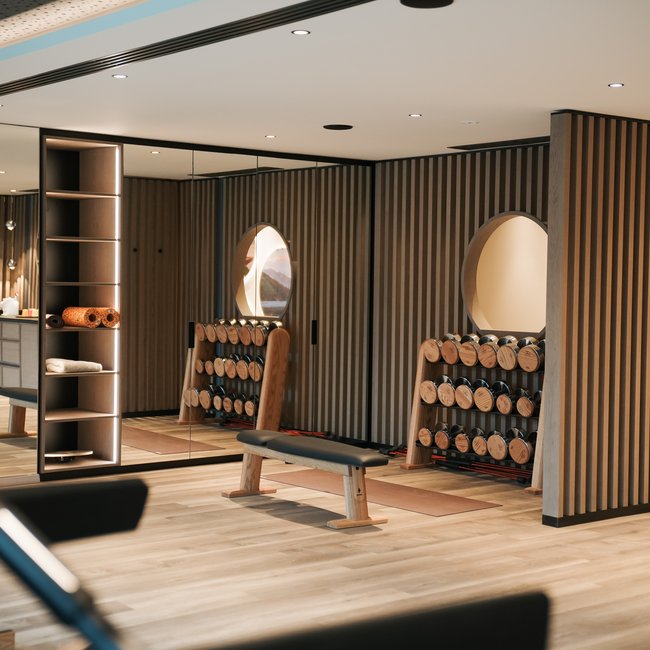 Sporthotels in Südtirol: Gartenhotel Moser Moderner Fitnessraum mit Hanteln, Bank und Holzverkleidung an den Wänden
