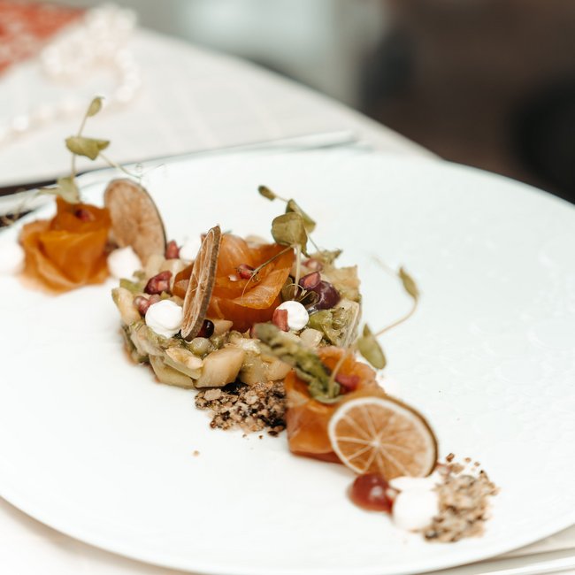 Wellness hotel with gourmet cuisine: Gartenhotel Moser Finely plated gourmet dish with herbs and dried lemon slices