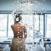 Hotels near Lago di Caldaro with 4-star superior service Woman with towel in spa room with hanging crystal decorations