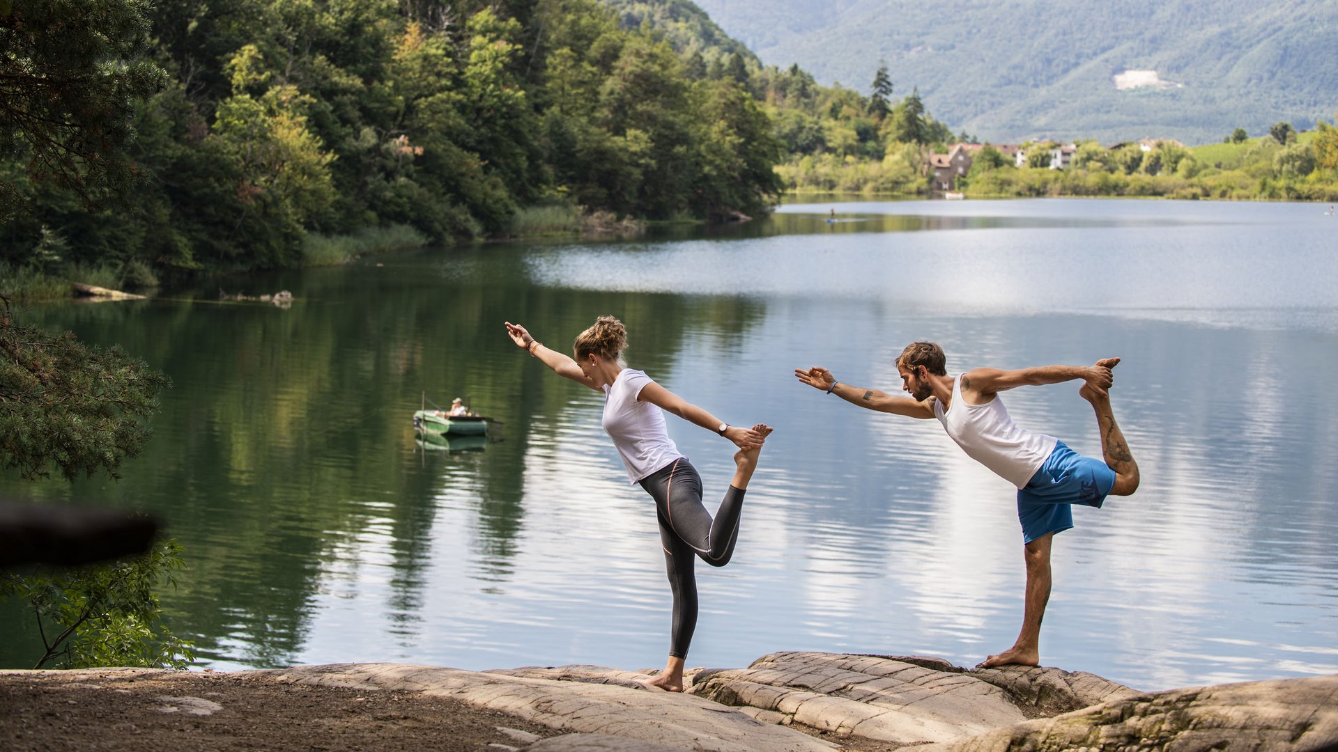 Lakeside wellness holiday: Gartenhotel Moser Couple practicing yoga by lake with forest and mountains in the background